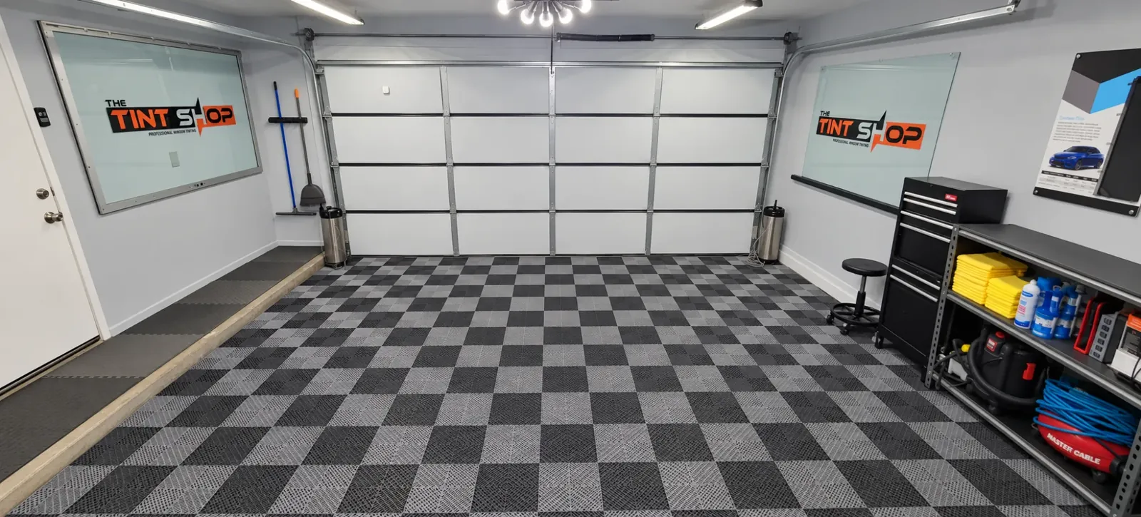 Inside The Tint Shop’s Phoenix workspace, with The Tint Shop logo on the frosted glass
